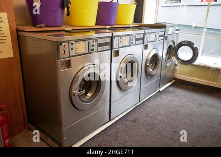 row of washing machines in a launderette in ambleside lake district, cumbria, england, uk Stock Photo