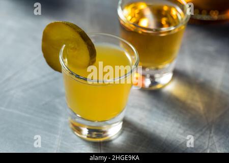 Boozy Cold Pickleback Shot Cocktail with Irish Whiskey Stock Photo