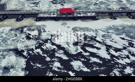 Elevated view of the trestle (friendship) trail in winter. The trail goes across the lake from one city to another. The water is frozen over with snow Stock Photo