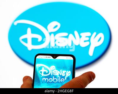 Ukraine. 20th Jan, 2022. In this photo illustration, the Disney Mobile logo is seen displayed on a smartphone screen with the Disney logo in the background. (Credit Image: © Igor Golovniov/SOPA Images via ZUMA Press Wire) Stock Photo