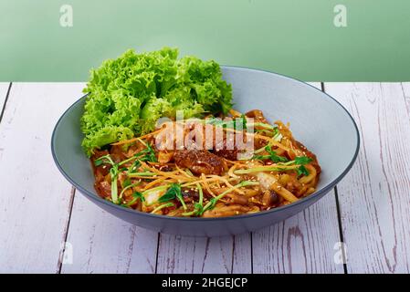 korean food Udon Bulgogi Lion Mane in a bowl on wood table background Stock Photo