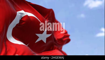 Detail of the national flag of Turkey waving in the wind on a clear day. Democracy and politics. Patriotism. Selective focus. Stock Photo