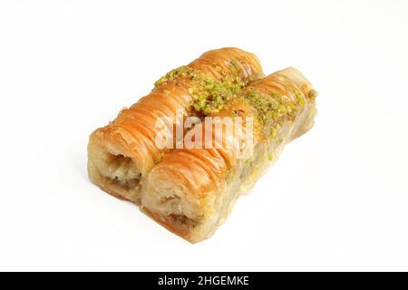 Rolled baklava with pistachios isolated on white background. Turkish delicacy Stock Photo