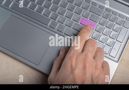 Pressing Enter button on laptops keypad, keyboard Stock Photo
