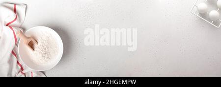Baking background with flour, eggs, kitchen tools, utensils and cookie molds on white marble table. Top view. Flat lay style. Mock up. Stock Photo