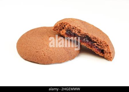 Brown tea biscuits with cherry filling isolated on white background Stock Photo