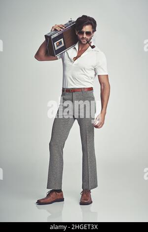 Stepping out with his tunes - 70s style Stock Photo