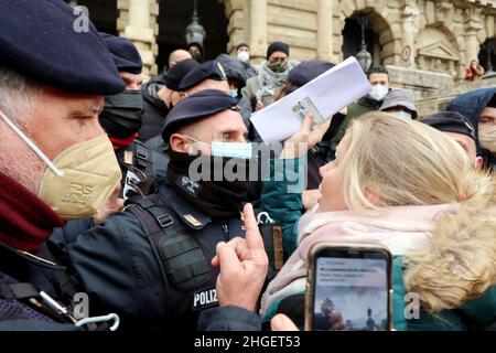 Police prevent No Vax MP Sara Cunial to enter Court of Cassation, Rome, Italy, on January 20, 2022. According to the latest Italian Government's rules, to enter Courts, as to enter offices, hairdressers, buses, trains, restaurants, cinemas, gyms, etc, is mandatory the 'Green Pass' certificate. To obtain a valid Green Pass one should get two Covid 19 vaccine doses or be healed from the infection. Moreover, Covid 19 vaccine is mandatory for all workers and for people over 50 years old. No Vax lawyers fight for their right to defend their clients without the Green Pass certificate and ask Ital Stock Photo