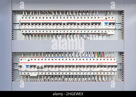 Electrical switchboard with different colored wires and sensors. Electricity equipment. Stock Photo