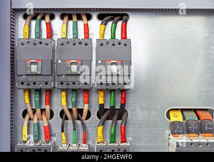 Electrical switchboard with different colored wires and sensors. Electricity equipment. Stock Photo