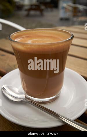 flat white coffee on an outdoor cafe table hawkshead lake district, cumbria, england, uk Stock Photo