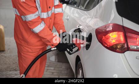 Gas station worker refilling car at service station Stock Photo - Alamy