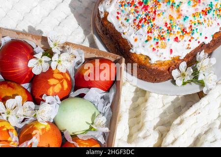 Easter cake and colored eggs for the celebration of Holy Easter. Flat lay. Stock Photo