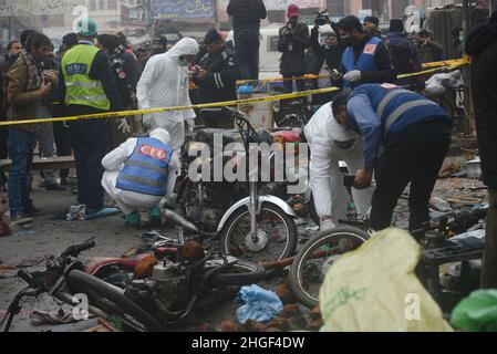 Lahore, Punjab, Pakistan. 20th Jan, 2022. Pakistani investigators gather evidence as they examine the site of a bomb explosion in Lahore. Police said the powerful bomb exploded in a crowded Anarkali bazar in Pakistan's second largest city of Lahore at least four people were killed and 28 injured in a blast officials said. (Credit Image: © Rana Sajid Hussain/Pacific Press via ZUMA Press Wire) Stock Photo