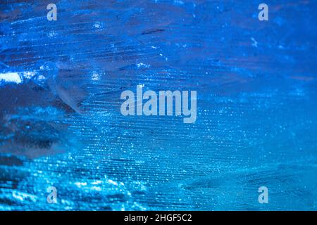 closeup of ice with colourful backlight for design purpose, textured background Stock Photo