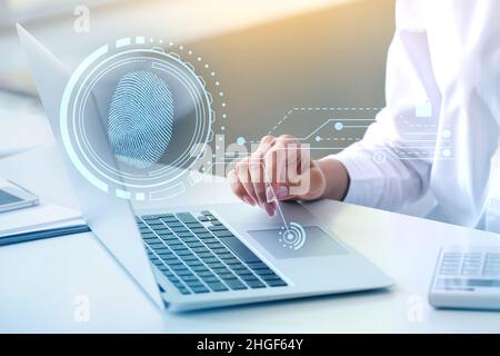 Young businesswoman logging into electronic personal account in office Stock Photo
