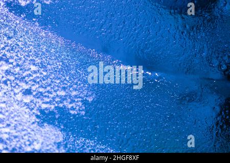 closeup of ice with colourful backlight for design purpose, textured background Stock Photo