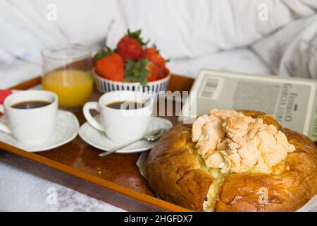 Tray with a breakfast for two with coffee, a panquemao, a typical Easter sweet in Valencia and a bowl with strawberries Stock Photo