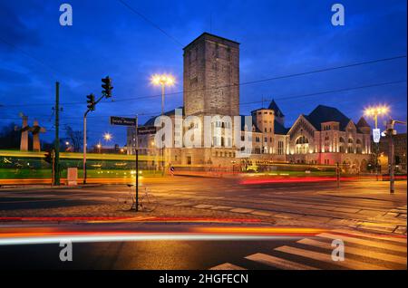 Poznan, Wielkopolska, Poland - imperial castle, prussian architecture and tram at night Stock Photo