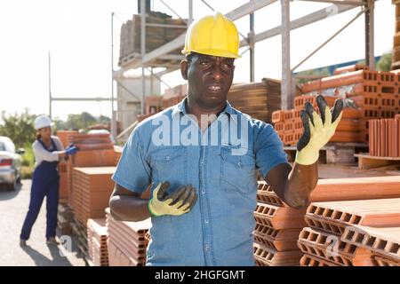 Portrait of a concentrated african american man worker standing in a warehouse Stock Photo