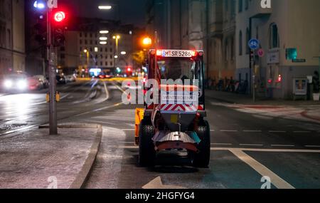 Munich, Germany. 21st Jan, 2022. A small snowplow stands at an intersection downtown. Credit: Sven Hoppe/dpa/Alamy Live News Stock Photo