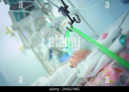 Newborn baby connected to the life support equipment in the NICU. Stock Photo