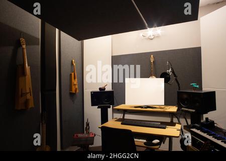 Music studio full of instruments and pc display Stock Photo - Alamy