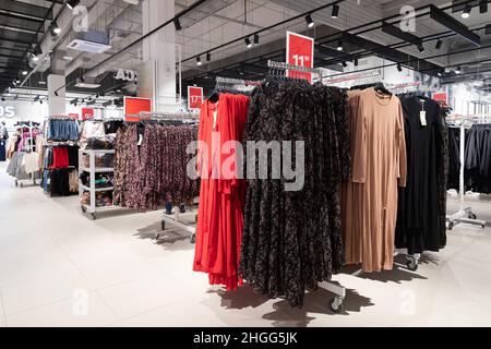 women's fashion store, evening dresses on hangers in a wide range Stock Photo