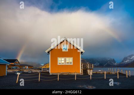 Yellow cabin in Sakrisoy with rainbow, Moskenes, Moskenesoya, Nordland, Lofoten, Norway, Northern Europe Stock Photo