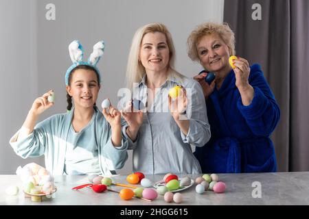 family grandmother and child granddaughter with ears hare getting ready for holiday, easter Stock Photo