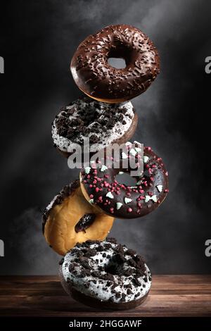 empty wooden table with smoke float up on dark background Stock Photo