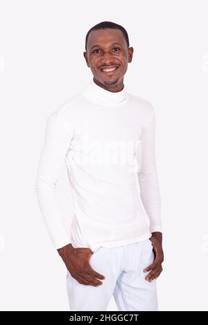 happy adult businessman posing while holding his thumbs in pockets and smiling at camera Stock Photo