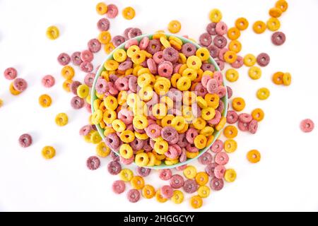A top view of multicolored fruity cereals in a bowl isolated on white background Stock Photo