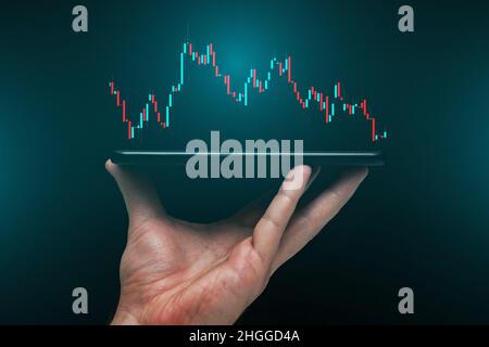 Stock market, Business growth, progress or success concept. Hand of Businessman or trader is showing a growing virtual hologram stock on smartphone Stock Photo