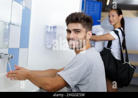 man washing hands in bathroom washbasin Stock Photo