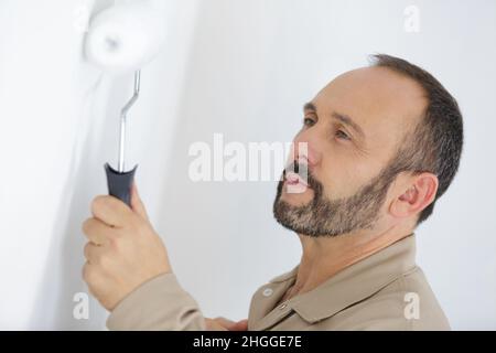painter portrait with paint roller Stock Photo