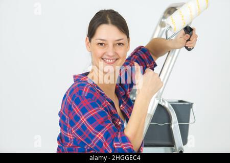portrait of female painter apprentice showing thumb up Stock Photo