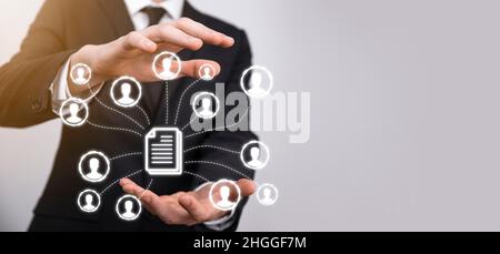 Man hold document and user icon.Corporate data management system DMS and document management system concept. Businessman click or publish on document Stock Photo