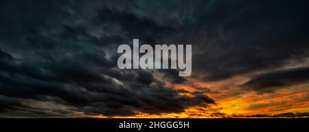 Panorama of a Dramatic sky at stormy sunset. Dark clouds before a thunder storm Stock Photo