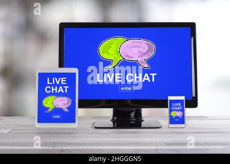 Live chat concept shown on different information technology devices Stock Photo