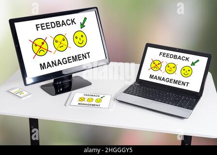 Feedback management concept shown on different information technology devices Stock Photo
