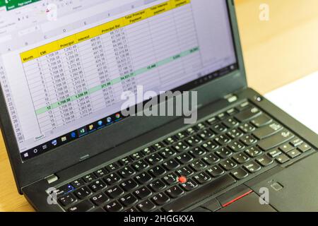 Shot of an excel sheet on laptop screen showing bank loan amortization table. Stock Photo