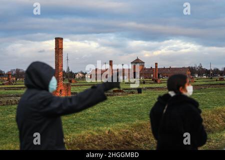 Brick crematorium chimneys left in ruins and the Gate of Death, the main entrance of the former Nazi-German Auschwitz II-Birkenau concentration and extermination camp in Oswiecim, Poland on January 3, 2022. Stock Photo