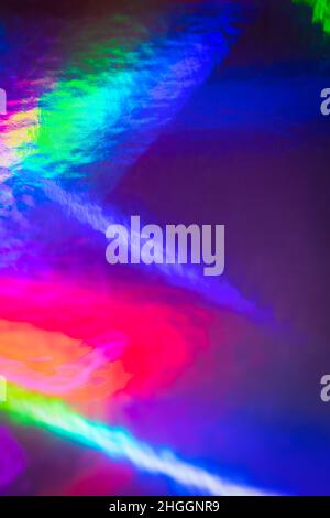 Iridescent holographic foil background. Bright vibrant colors backdrop. Trendy creative gradient. Vertical photo Stock Photo