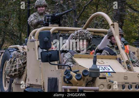 Three men in combat gear & camouflage helmets in Jackal reconnaissance vehicle. Royal Yeomanry Light Cavalry Army Reserve regiment. Lord Mayor's Show. Stock Photo