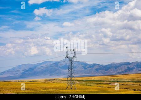 High voltage power tower and beautiful mountain scenery in Xinjiang,China. Stock Photo