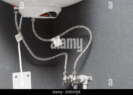 System for connecting hot and cold water hoses to the boiler. Stock Photo