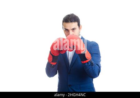 Businessman with red boxing gloves stands in fighting position. Portrait of determined business person prepared for battle isolated on white backgroun Stock Photo