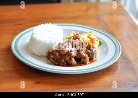 stewed pork ,pork with rice and sauce or rice with stew pork and vegetable Stock Photo