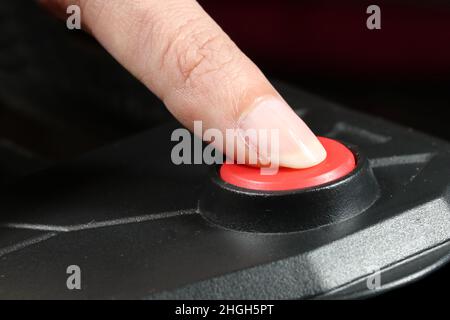 Pressing STOP or START button. Finger presses the red button. Stock Photo